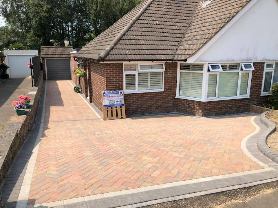 Brindle herringbone block paved driveway to a garage